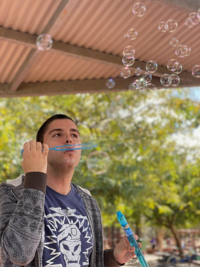 a man blowing bubbles