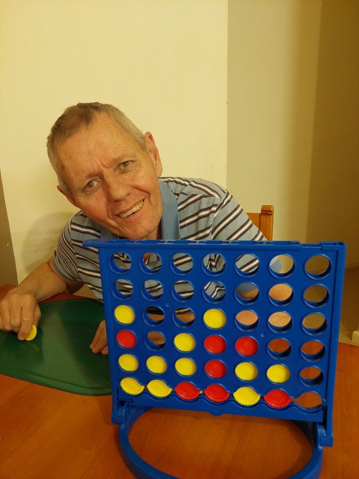 a man sitting at a table with a board game