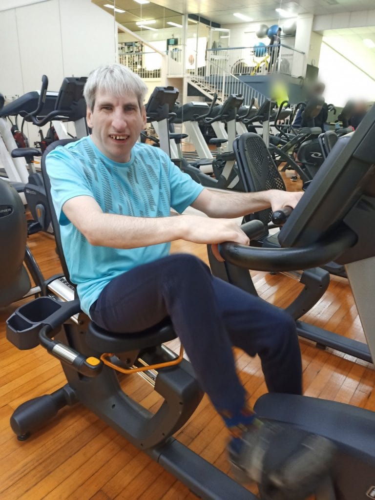 a man sitting on an exercise bike in a gym