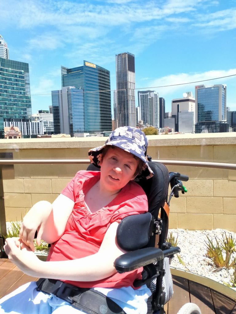 a woman sitting in a wheel chair on a roof