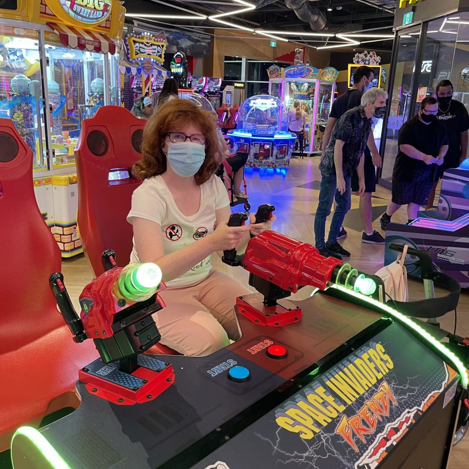 a woman wearing a face mask playing a game
