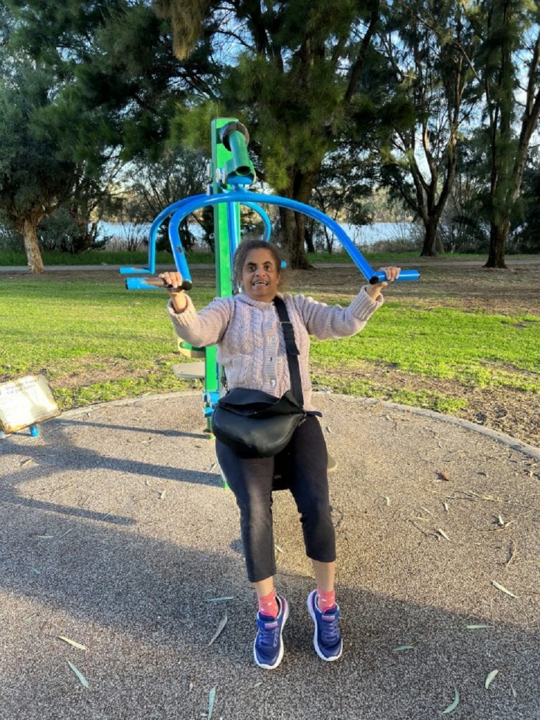 a woman on a swing in a park
