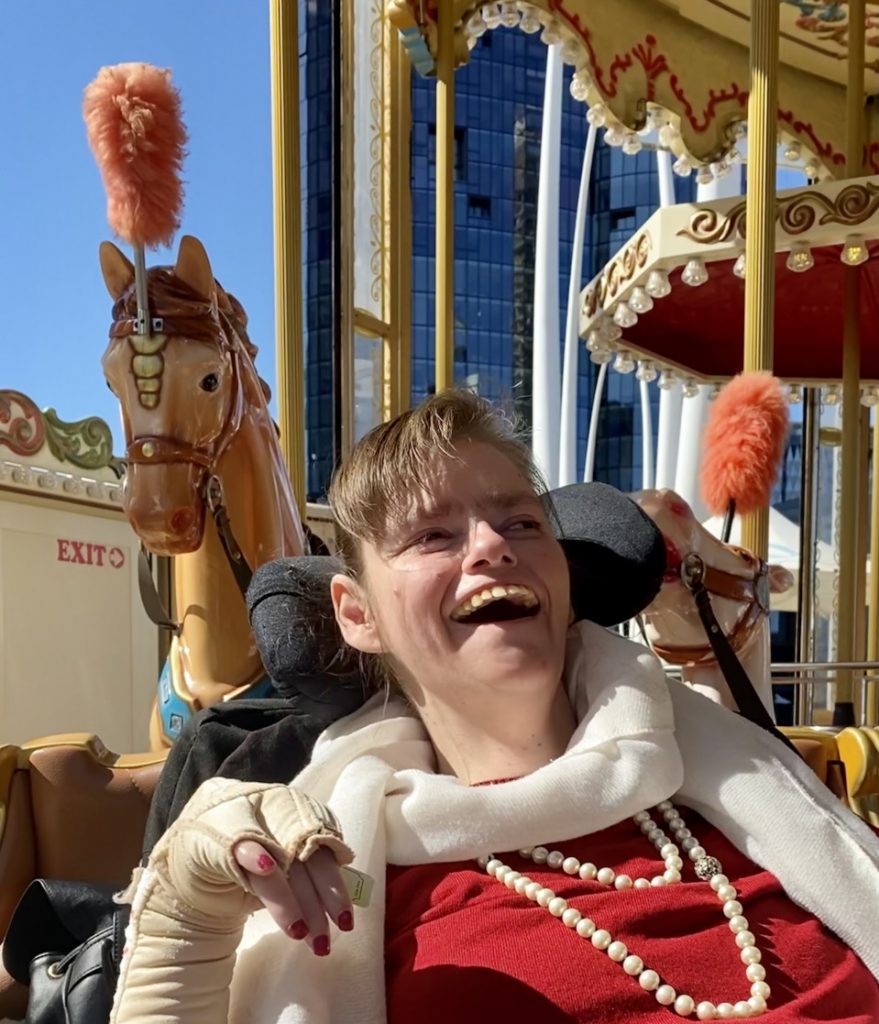 a woman in a costume rides a merry go round