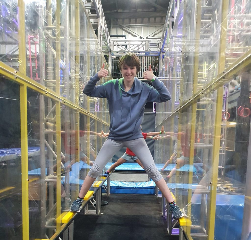 a young man is standing on a trampoline