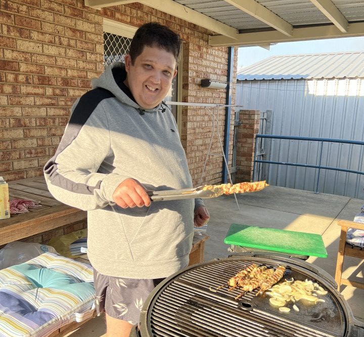 a man grilling food on an outdoor grill