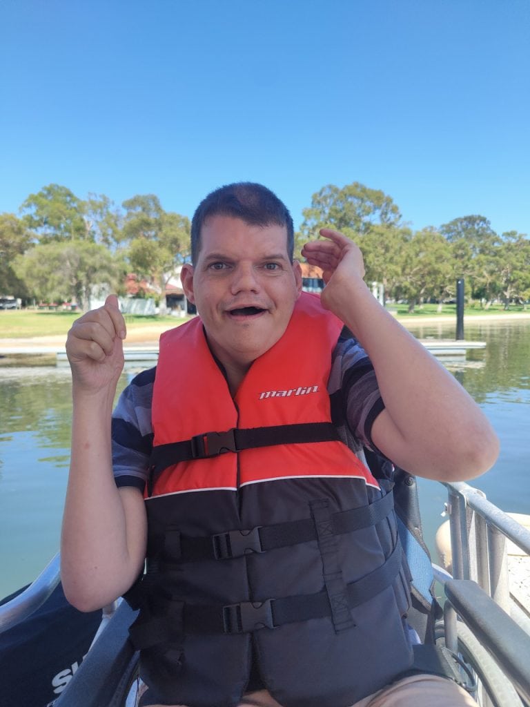 a man in a life jacket sitting in a boat
